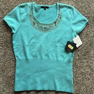 Reba skirt sleeve sweater with fitted waist. Embellished with pewter and gold.